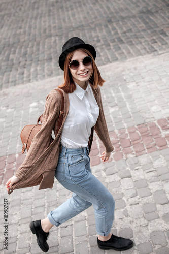 Active happy  young woman walking in the city