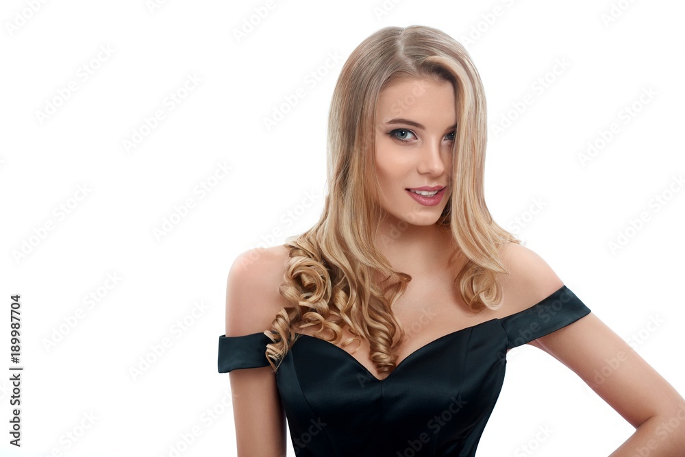Portrait of a beatiful girl with blonde curly hair in a nice evening dress with a open top. Photo was made on the white studio background. Portrait of a beatiful girl with blonde curly hair in a nice evening dress with a open top. Photo was made on the white studio background.