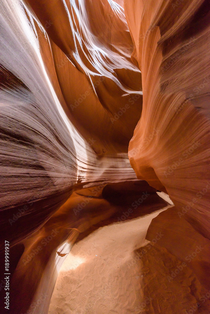 Obraz premium Small Path through Upper Antelope Canyon. Natural rock formation in beautiful colors. Beautiful wide angle view of amazing sandstone formations. Near Page at Lake Powell, Arizona, USA