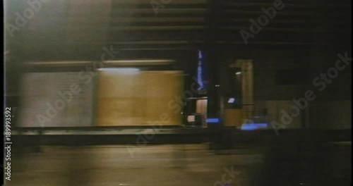 View from the train of dark unlighted train station and cities at night, transportation in Denmark and around Copenhagen - point of view pov of passenger - vintage VHS video tape photo