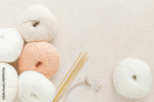 fluffy yarns, pastel angora, wooden knitting needles, earphones