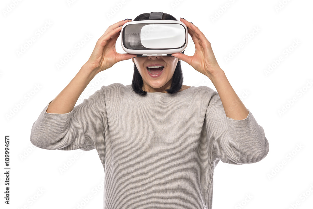 Young woman in a virtual reality helmet on a white. Young woman in a virtual reality helmet on a white.
