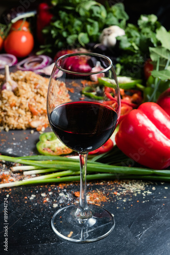 A glass of semisweet or dry red wine on vegetable background. National Georgian alcohol drinks. Wine pairing concept