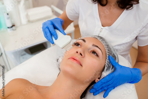 Ultrasonic cleaning of the face for a woman.