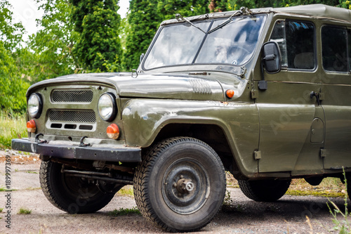 An old Soviet car, a green SUV