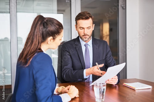 Recruiter conducting business job interview with female applicant in office photo