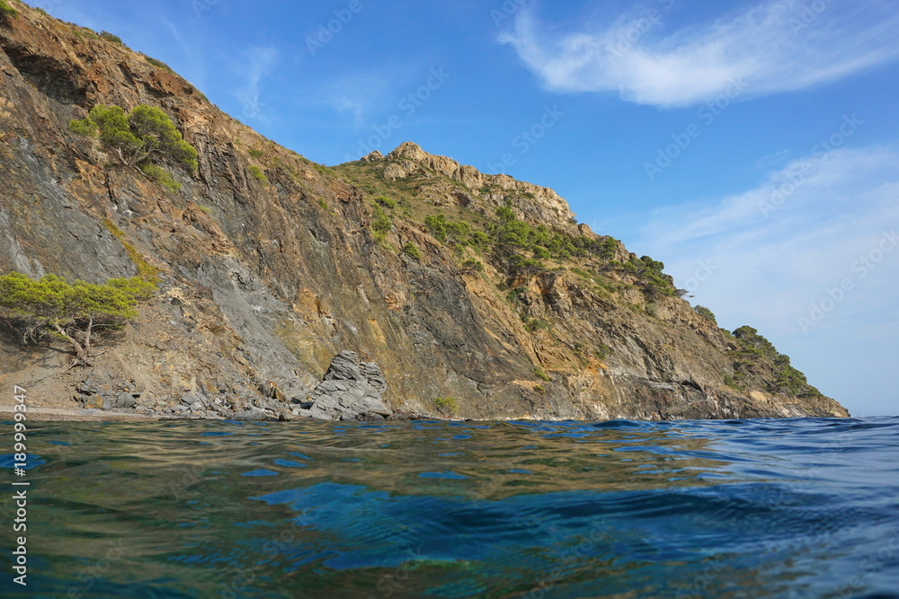 Spain Costa Brava coastal landscape cliff seen from water surface, Cap Norfeu, Mediterranean sea, Alt Emporda, Girona, Catalonia