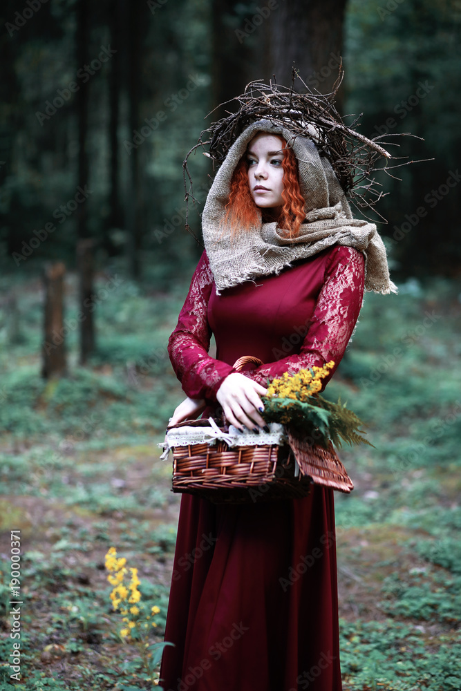 The red-haired witch holds a ritual with a crystal ball The red-haired witch holds a ritual with a crystal ball