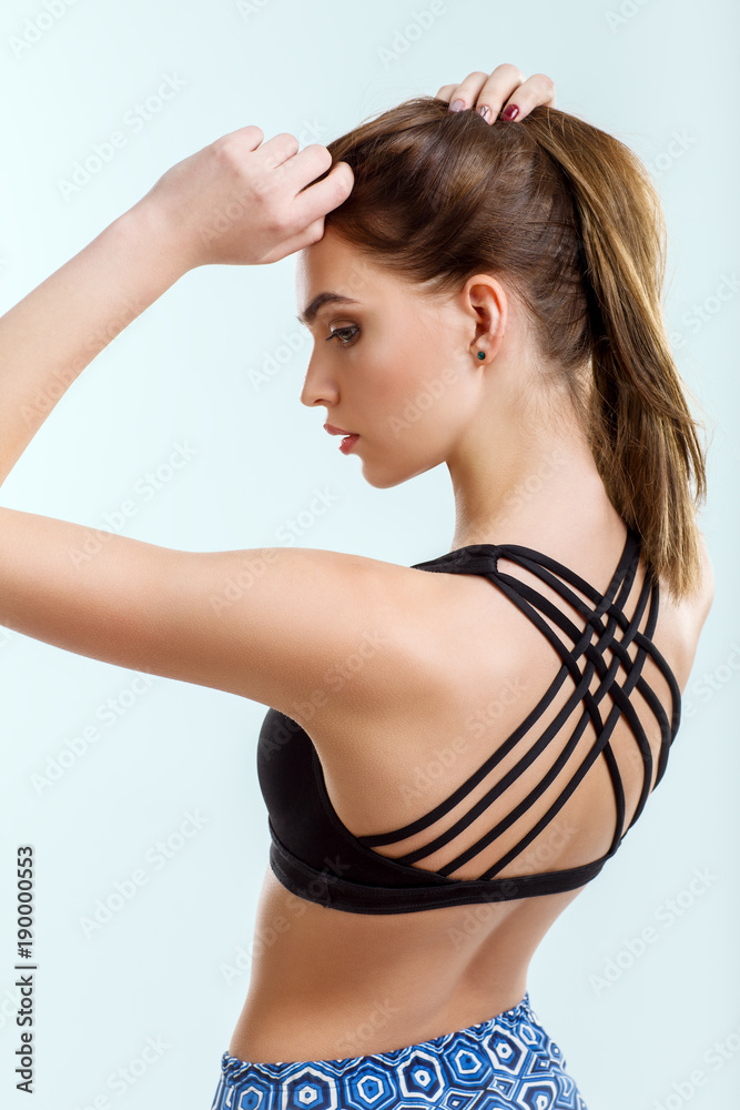 Back view of attractive woman in swimsuit posing in studio Back view of attractive woman in swimsuit posing in studio
