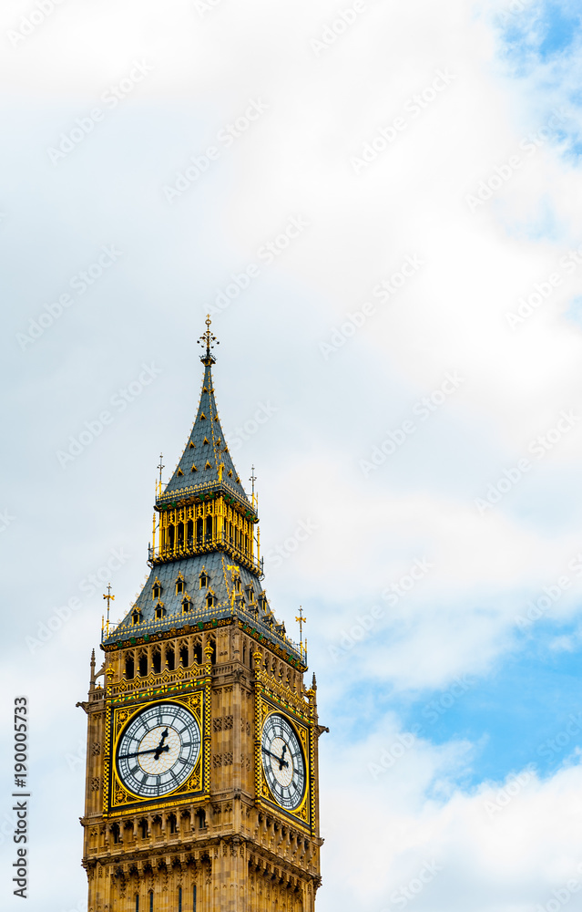 Big Ben clock tower, London UK set against clouds in sky with copy space top and side