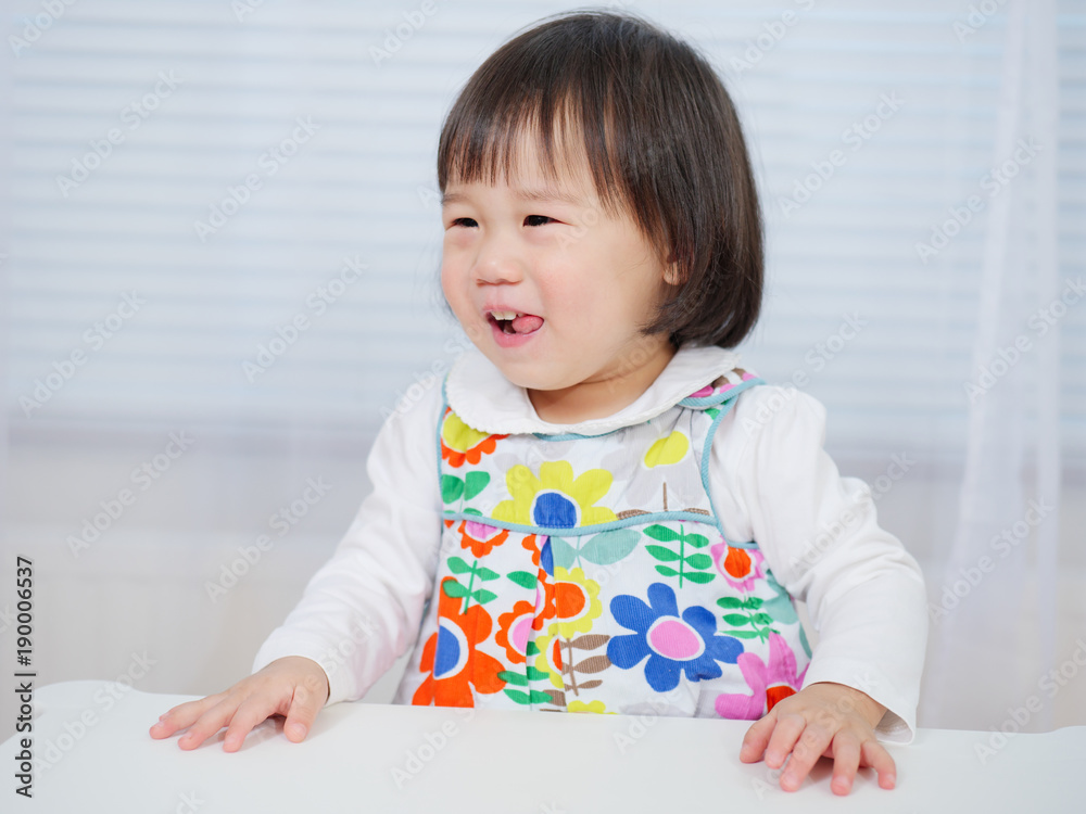 smiling baby girl sitting on chair at home smiling baby girl sitting on chair at home