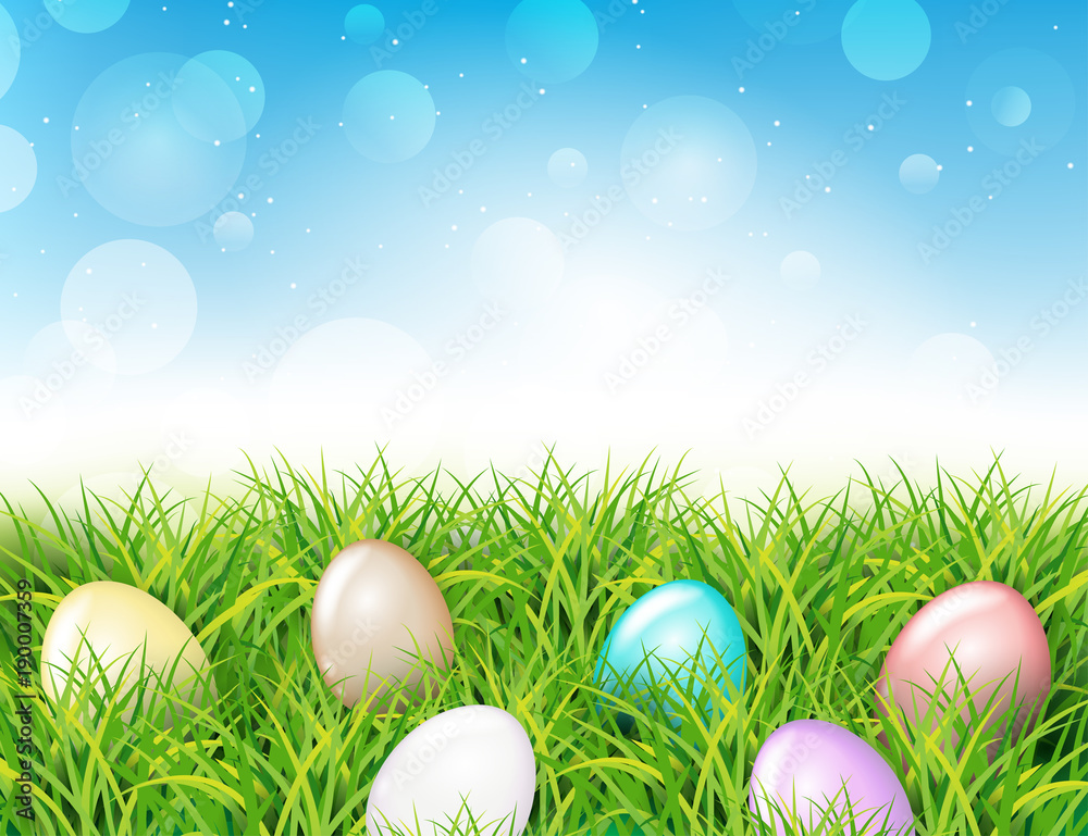 Colorful Easter eggs in grass. Spring landscape with blue sky. Greetig card template. Spring easter design