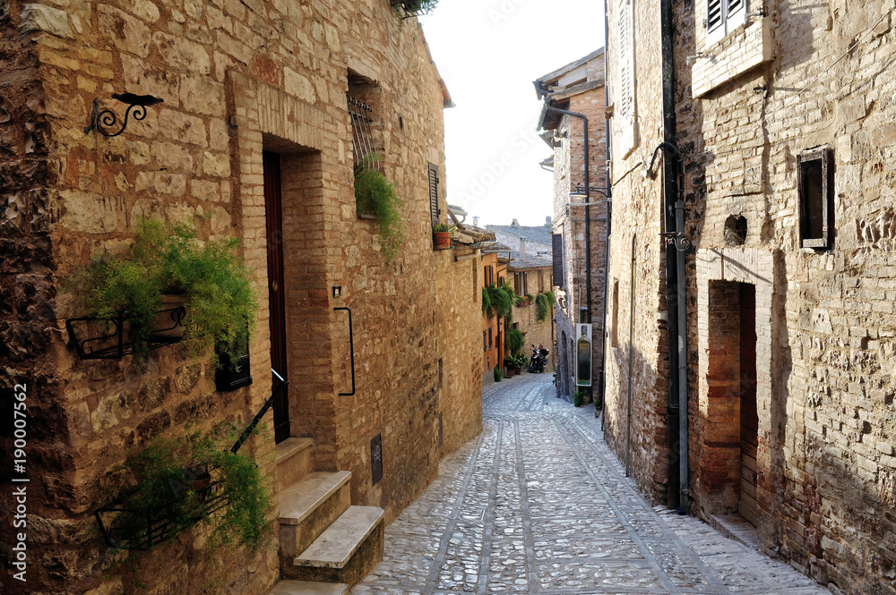 Traditional italian medieval alley in the historic center of beautiful little town of Spello, Perugia , in Umbria region - central Italy