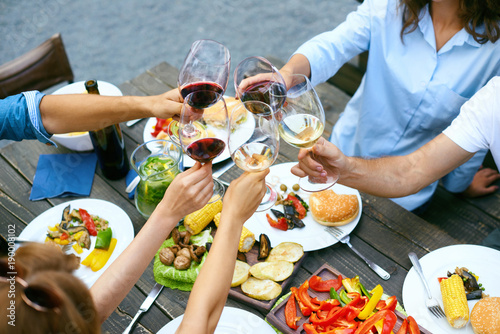 Canvas Print People Cheering With Drinks At Outdoor Dinner Party