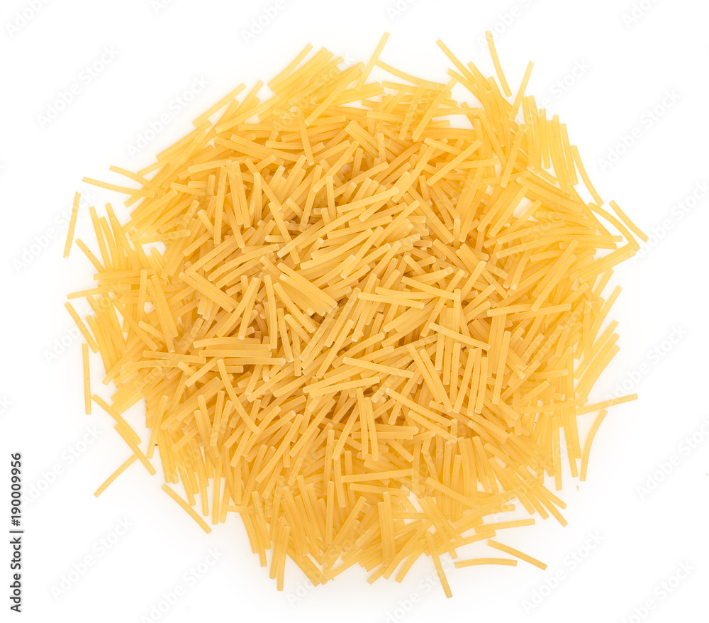 Heap of uncooked dry vermicelli, noodles, pasta, isolated on a white background, close up, top view.