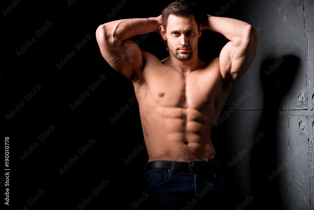 Fitness concept. Muscular and sexy torso of young man having perfect abs, bicep and chest. Male hunk with athletic body. Fitness concept. Muscular and sexy torso of young man having perfect abs, bicep and chest. Male hunk with athletic body.