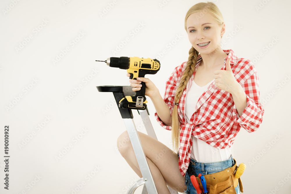 Girl using some power tools for work at home Girl using some power tools for work at home