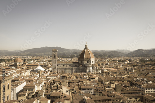 Florentine cityscape with the Florence Cathedral in a sunny day, Tuscany, Italy. Aged photo effect. photo
