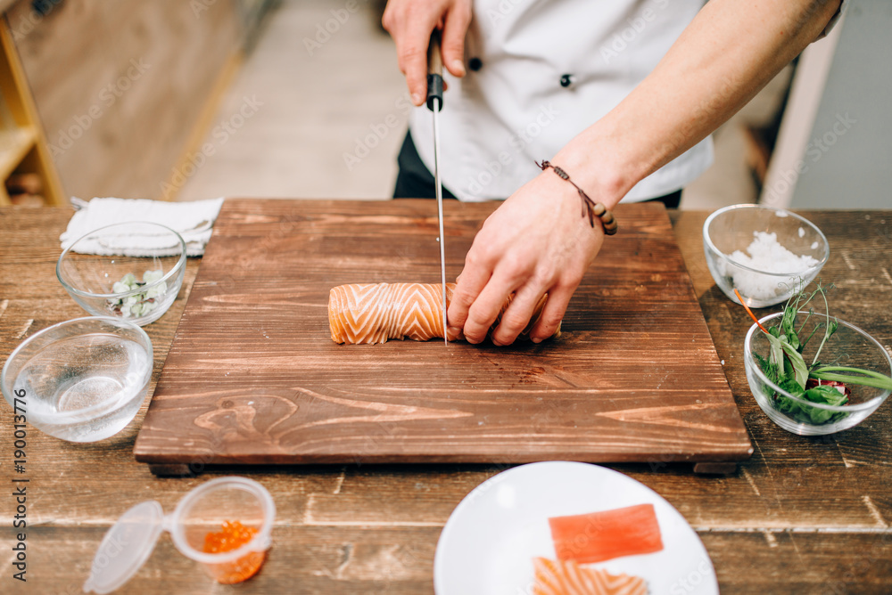 Male person cooking seafood, japanese food