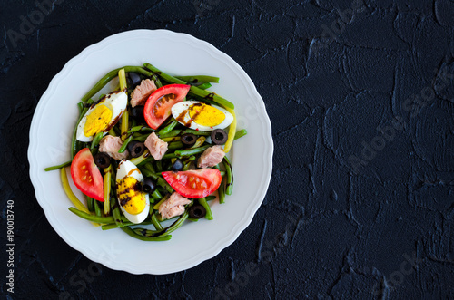 Warm salad with green beans  tuna  tomatoes and boiled eggs
