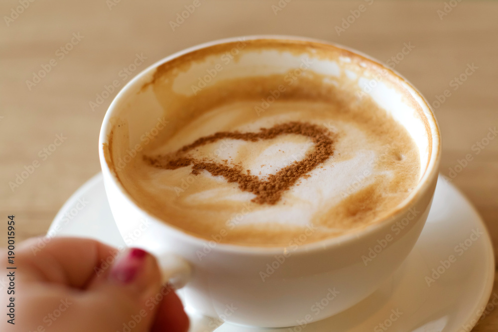 Cup of cappuccino with heart. Girl drinking cappuccino. Cup of coffee in female hands. Cup of cappuccino with heart. Girl drinking cappuccino. Cup of coffee in female hands.