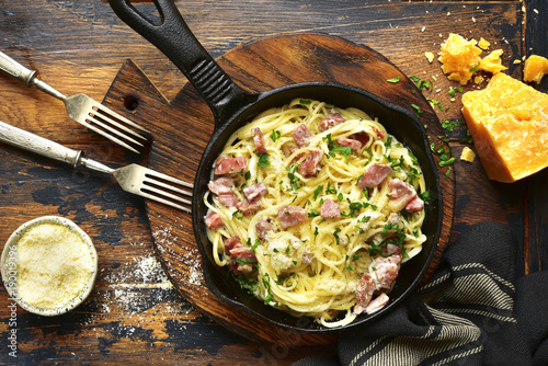 Traditional italian dish spaghetti carbonara with bacon in a cream sauce.Top view with copy space. photo