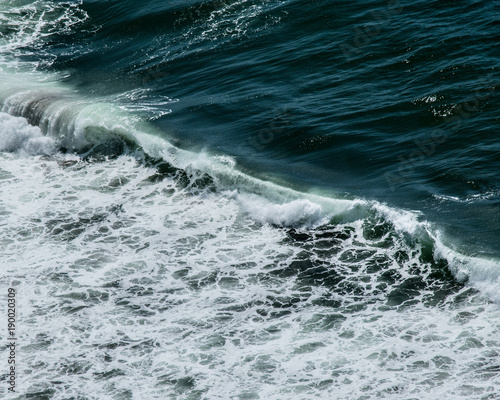 CURLING OCEAN WAVES AND DEEP GREEN SEA OREGON COAST