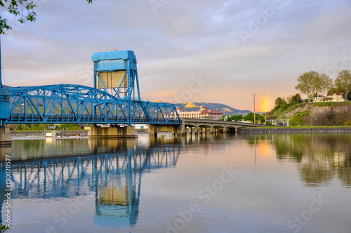Lewiston - Clarkston blue bridge reflecting in the Snake River against evening sky photo