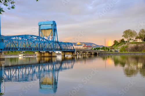 Lewiston - Clarkston blue bridge reflecting in the Snake River against evening sky
