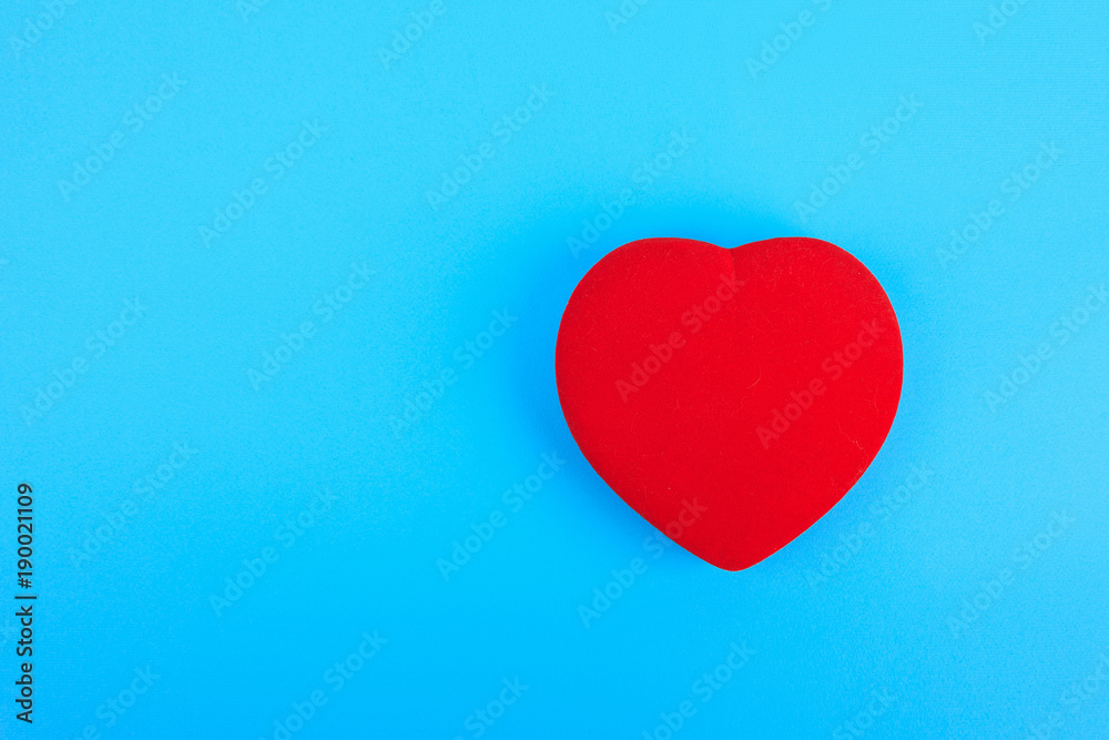 bright red heart with copyspace on blue background bright red heart with copyspace on blue background