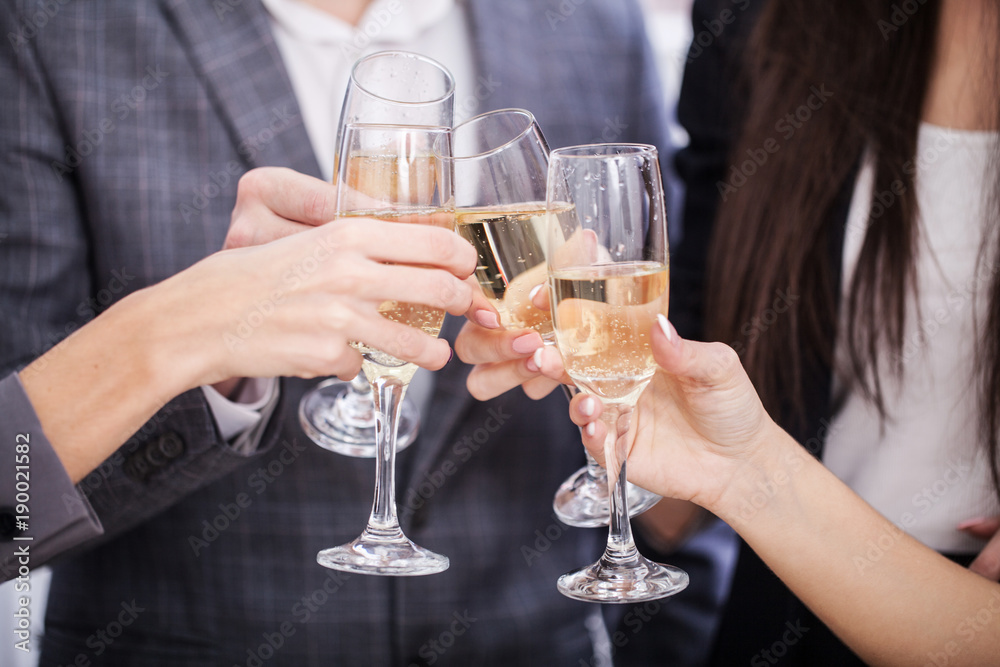 Close up of business team toasting with Champagne