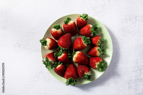 a pile of fresh juicy ripe strawberries on the plate
