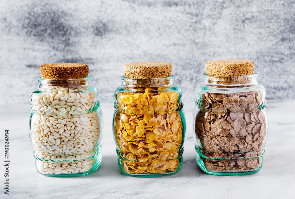 Variety of cold quick breakfast cereals in glass jars , healthy eating for kids and athletes. concept of a healthy lifestyle. gluten-free diet