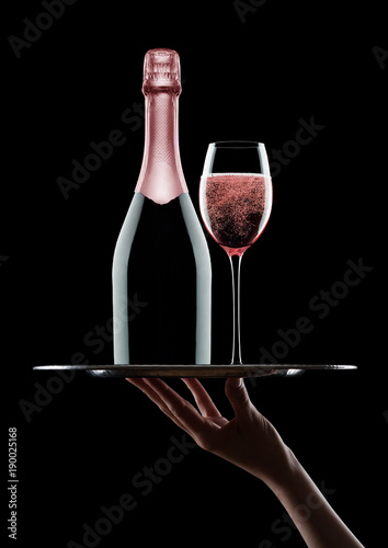 Hand holds tray with pink rose champagne glasses © DenisMArt