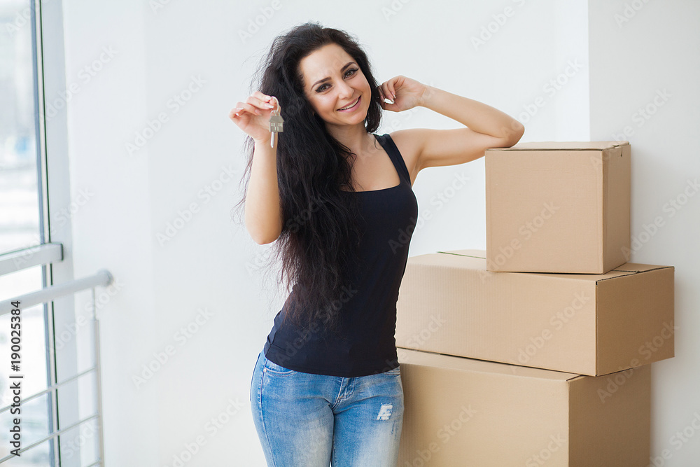 Happy young woman moving to new home - having fun Happy young woman moving to new home - having fun