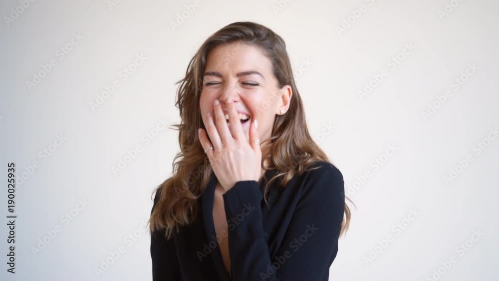 Excited young woman smiling at camera on white background Excited young woman smiling at camera on white background