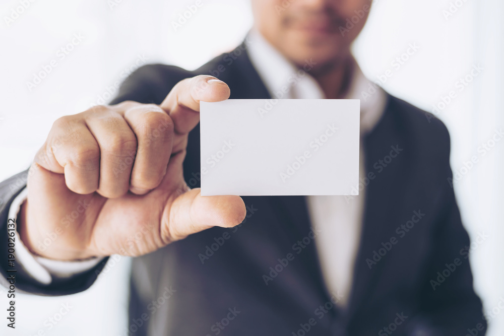 businessman holding and showing empty business card or name card - business concept businessman holding and showing empty business card or name card - business concept