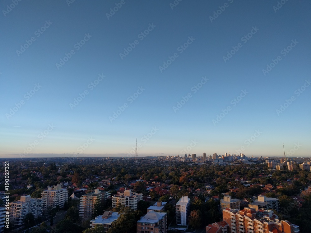 Sydney city seen from the Northern distance at sunset