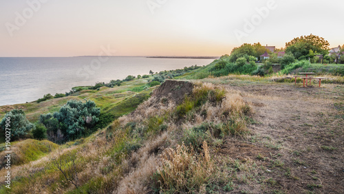 The shore of Taganrog Bay in the Rostov region in the rays of the setting sun photo