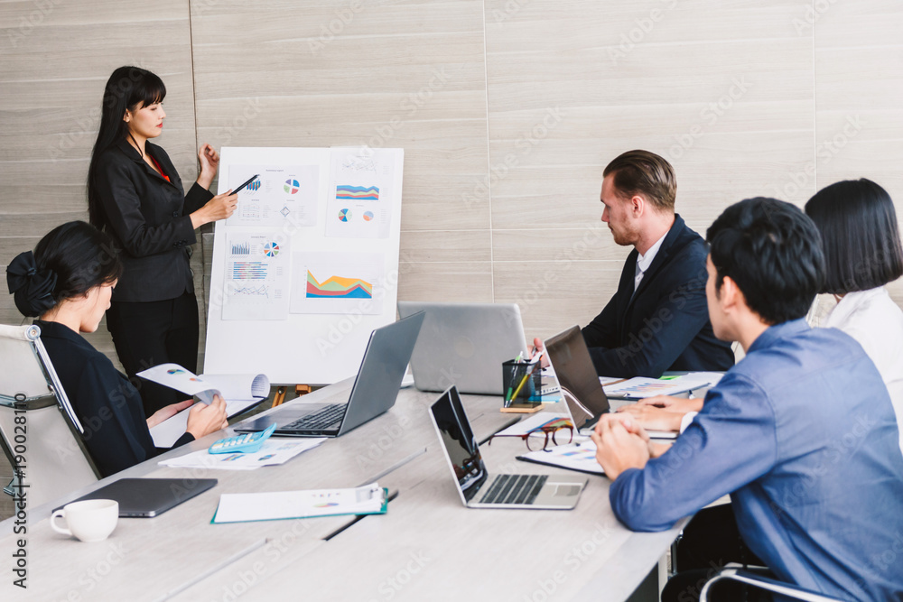 Businesspeople using laptops and discussing together in meeting room.Teamwork concept Businesspeople using laptops and discussing together in meeting room.Teamwork concept