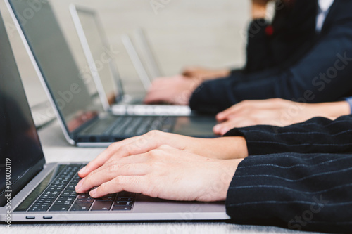 Businesspeople using laptops and discussing together in meeting room.Teamwork concept © Art_Photo