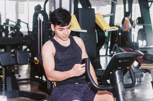 Fitness man execute exercise with exercise-machine at the gym