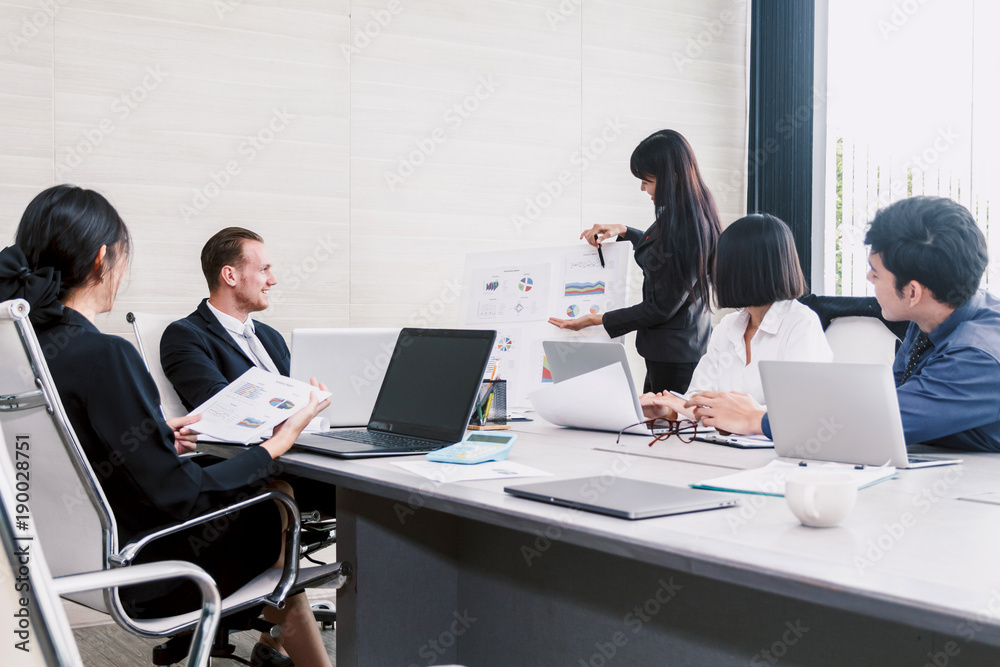 Businesspeople using laptops and discussing together in meeting room.Teamwork concept Businesspeople using laptops and discussing together in meeting room.Teamwork concept