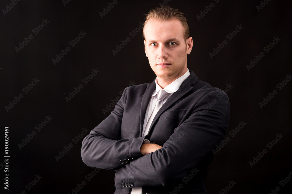Portrait of handsome businessman on dark background Portrait of handsome businessman on dark background