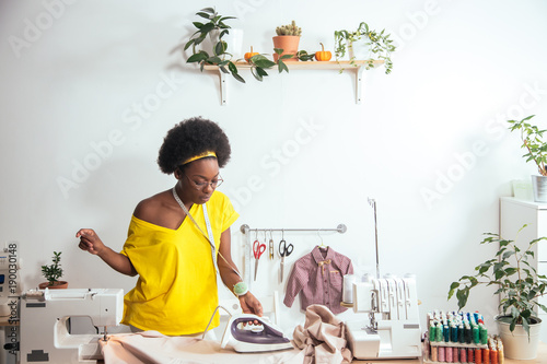 african Woman seamstress Ironing cloth in tailor shop