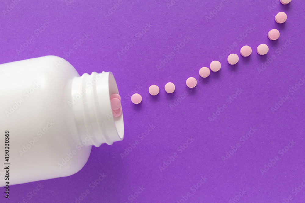 Capsules spilling out of white bottle. Violet background. Line, way course concept.