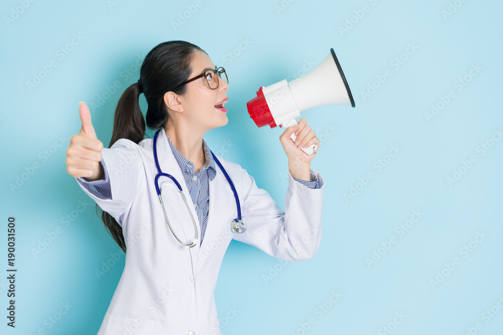 happy attractive woman doctor using loudspeaker happy attractive woman doctor using loudspeaker