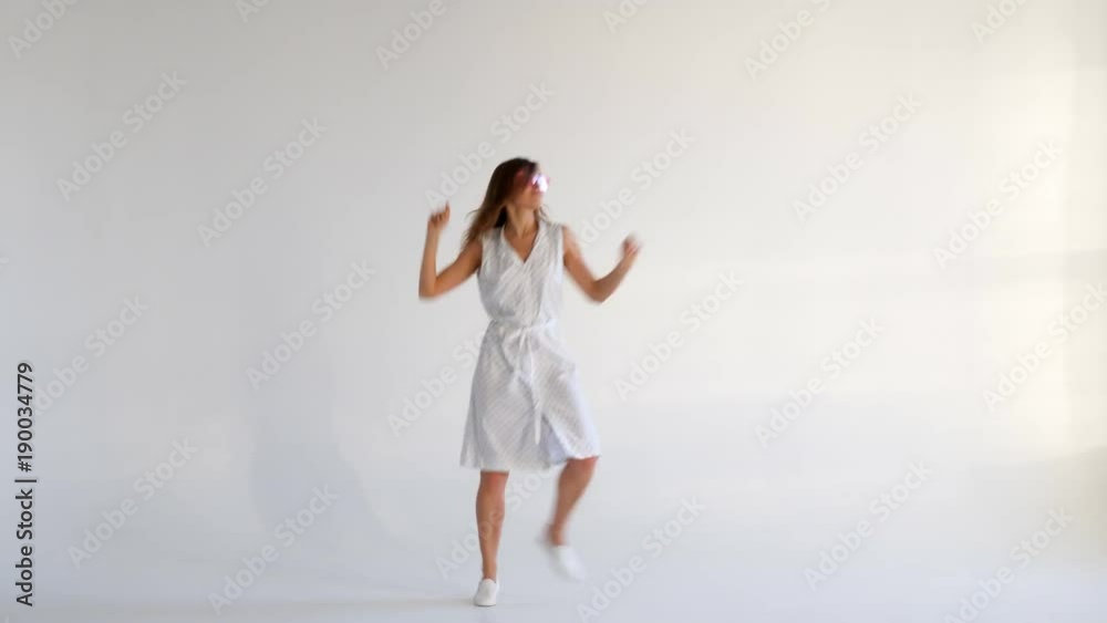 Graceful smiling girl posing while dancing on background Graceful smiling girl posing while dancing on background