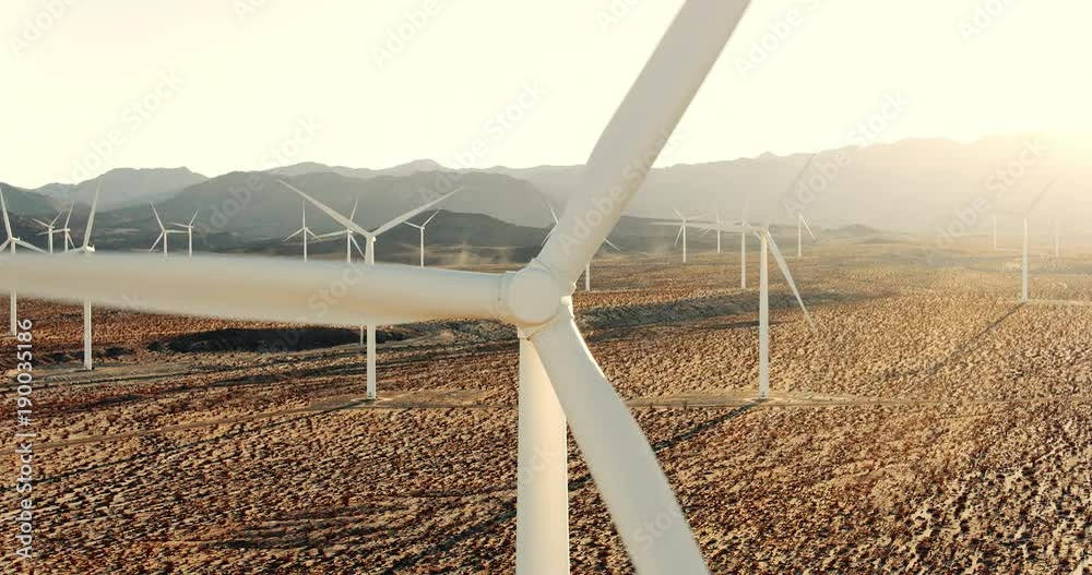 Closeup aerial view of wind turbine in desert 