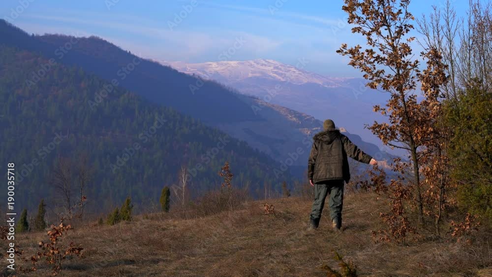 Man watching under tree and goes into distance - (4K) Man watching under tree and goes into distance - (4K)